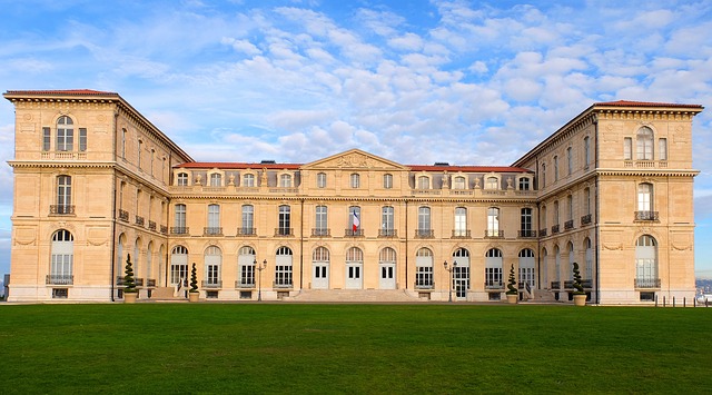 A historic Marseilles palace with a green lawn