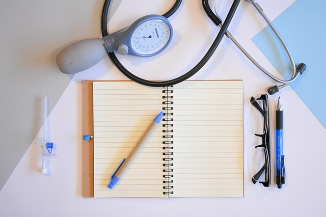 A notepad with glasses and a stethoscope around it